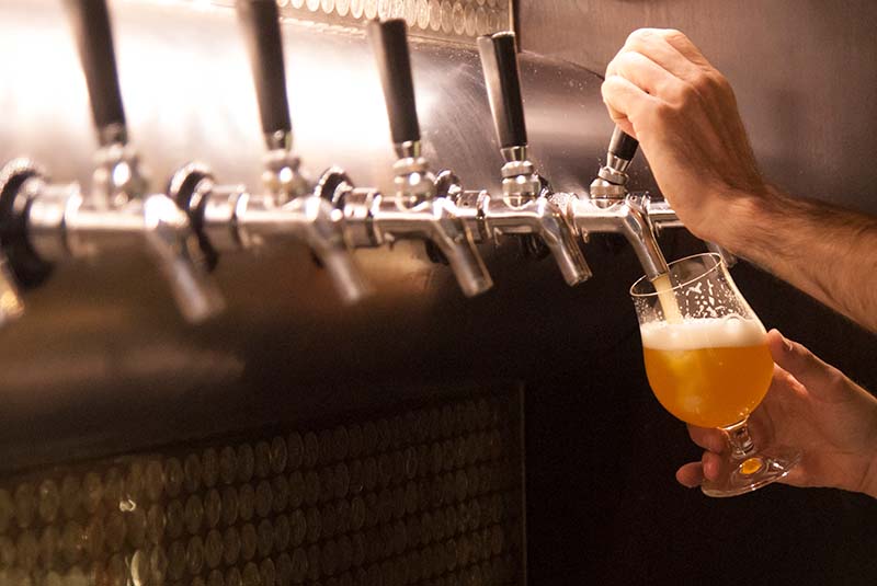 A fresh pint of beer being poured in a pub